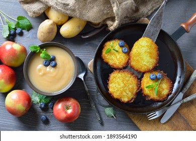 Crunchy Fried Potato Pancakes Served With Sweet Applesauce And Some Berries