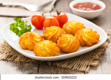 crunchy homemade pommes duchesse server on a plate - Shutterstock ID 359833223