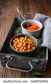 Crunchy Snack, Crispy And Spicy Oven Roasted Chickpea Covered In Paprika And Red Chilli Powder On Rustic Wooden Background