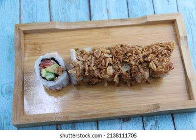 Crunchy Sushi Rolls On A Wooden Plate