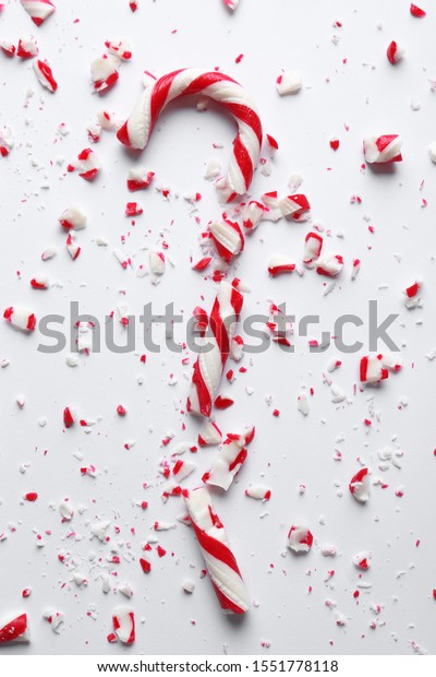 Crushed candy cane on white background, top view.\
Traditional Christmas\
treat