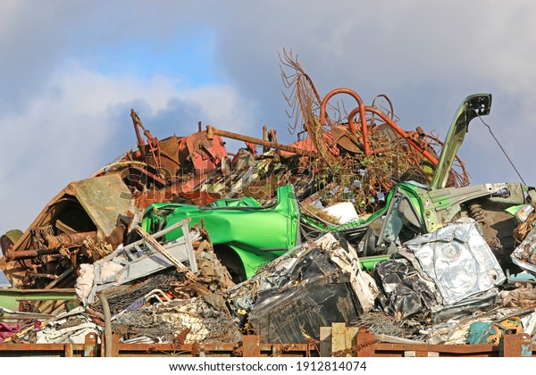 Crushed cars in\
a Scrap metal yard for\
recycling
