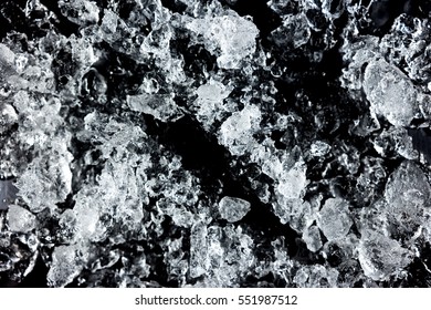 Crushed Ice Pattern On Black Background. Close Up