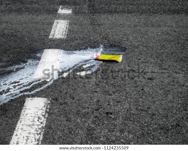 Crushed pack of\
milk on a crosswalk. Sign of road accident with pedestrian or\
high-level caution when cross a road\
