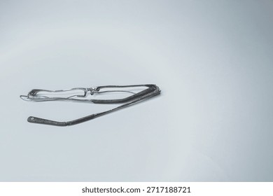 A crushed pair of eye glasses mangled.