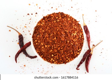 Crushed Red Cayenne Pepper, Dried Chili Flakes In A White Bowl, Isolated On White Background, Top View.