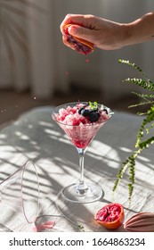 Crushed Red Ice In Martini Glass. Berry Granita With Mint And Blueberries. Harsh Light And Shadows. Natural Lighting. White Background. Sunlight With Large Shadows. Minimalist Food Photography.