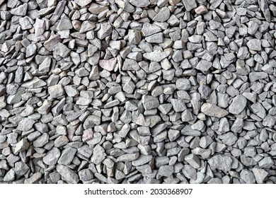 Crushed rock close up. Small rocks ground. Crushed stone road building material gravel texture. Small stone construction material rock. Garden gravel background stone landscaping. Driveway gravel road