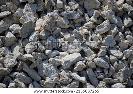 Crushed rock close up. Small rocks ground. Crushed stone road building material gravel texture. Small stone construction material rock. Garden gravel background stone landscaping. Driveway gravel road