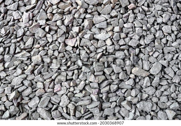 Crushed rock close up. Small rocks ground. Crushed\
stone road building material gravel texture. Small stone\
construction material rock. Garden gravel background stone\
landscaping. Driveway gravel\
road