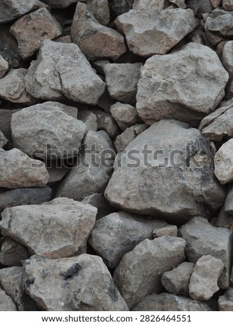 Crushed stone or coarse aggregate (split stone or macadam) is a construction material consisting of rock fragments that generally have sharp edges