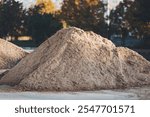 crushed stone of different fraction. A close-up of a pile of gray gravel with a smooth surface. A lot of construction sand near the site to build