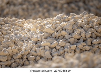 Crushed stone, selected focus. Crushed stones for road repair. Hills of crushed stone in the sunlight. Material for building roads or laying utilities - Shutterstock ID 2375055619