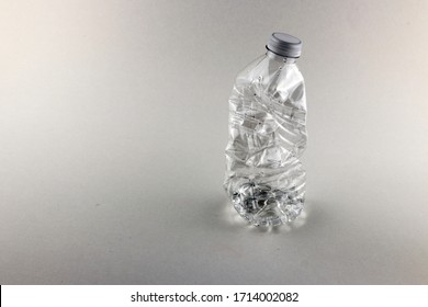 Crushed Water Bottle With Grey Background.