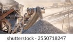 Crushing stones in a quarry for processing minerals, cement, limestone. Distribution and Screening Plant Gravel. Vibrating screen stone crusher in operation.