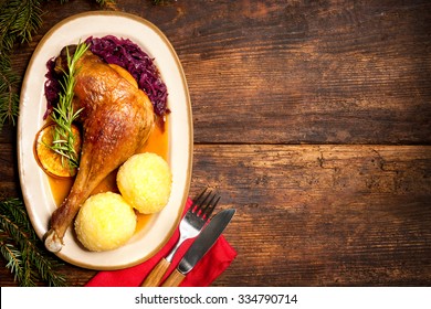 Crusty Goose Leg With Braised Red Cabbage And Dumplings. Cooking At Christmas Time