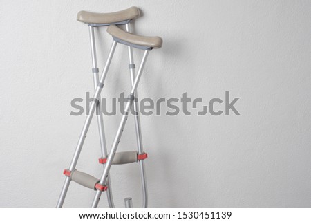 Crutches. Fractured legs. Crutches as a sign of disability. Symbol of disability. Rehabilitation in case of injury. Concept - workplace injury. Life with disabilities. Personal injury. Injuries. 