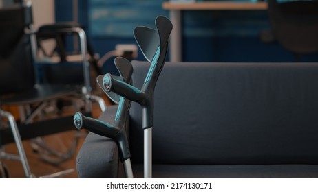 Crutches On Sofa To Help Person With Physical Disability. Empty Living Room With Walking Support For Transportation And Accessibility. Medical Equipment Helping With Mobility. Close Up