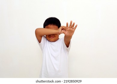 Crying Asian Boy Standing With Stop Hand Gesture. Isolated On White Background