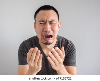 Crying Asian Man In Black T-shirt.