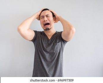 Crying Asian Man In Black T-shirt.