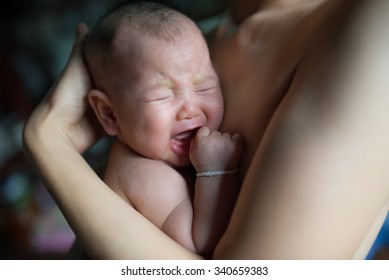 Crying Baby In Mother's Arms