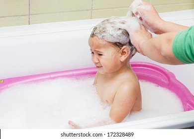 Crying Child During Bathing And Washing Hair.