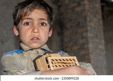 Crying Child Is Holding A Toy And Crying And His Expressions Are Full Of Pain 