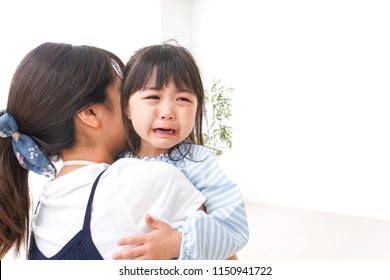 Crying Child And Mother