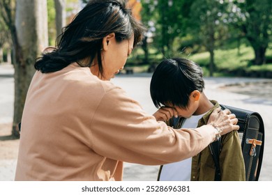 A crying elementary school student and a worried woman - Powered by Shutterstock