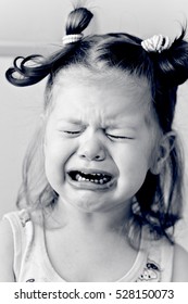 Crying little girl in black and white