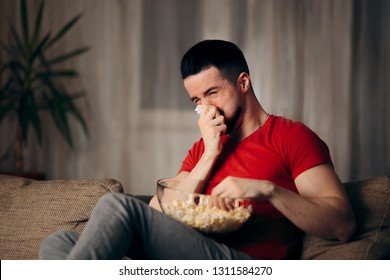 Crying Man Watching TV Eating Pop Corn. Young Millennial Guy Stress Eating Binging On Favorite Show
