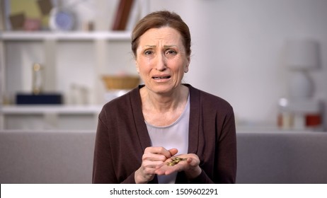 Crying Mature Lady Holding Coins Looking Camera, Low Salary, Poverty Problems