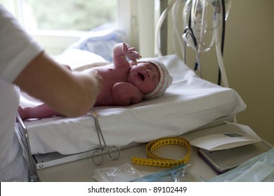 Crying Newborn Is Being Measured In Hospital