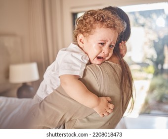 Crying, Sad And Tears Of Baby With Mom For Comfort, Safety And Attention While Hungry, Upset Or Tired In A Family Home. Toddler Boy Child Cry While In Arms Of Caring Woman Babysitter, Mother Or Nanny