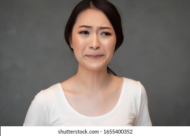 Crying Sad And Unhappy Asian Girl; Portrait Of Frustrated Depressed Chinese Or East Asian Woman Cries Out; Young Adult Chinese Asian Woman Model