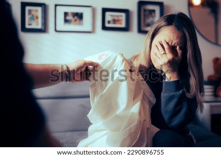 
Crying Wife Showing her Partner the Proof of Infidelity 
Unhappy woman feeling cheated and heartbroken 
