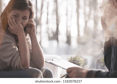 Crying woman with mental problem during therapy with psychiatrist