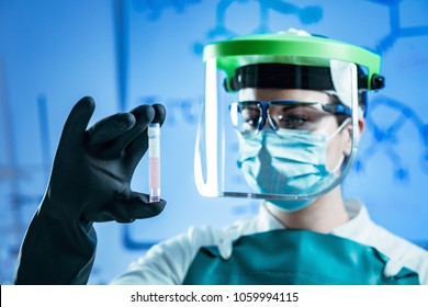 Cryopreservation. Biobanking technician in protective gear working with biological samples - Powered by Shutterstock