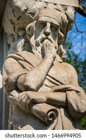 Crypt statue of a thinking old man with a scroll