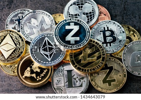 Crypto currency background with various of shiny silver and golden physical cryptocurrencies symbol coins, Bitcoin, Ethereum, Litecoin, zcash, ripple.