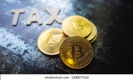 Crypto Currency  Bitcoin Coin With TAX Message Placed On A Dark Background, Contrast And Gold Color Of The Coin ,Concept Determining The Tax Law Of Digital Money.