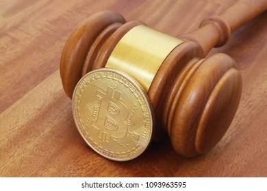 Crypto currency law concept, gavel and bitcoin coin on brown table