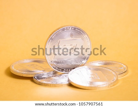 Crypto currency: a small pile of dashcoin on a yellow background.