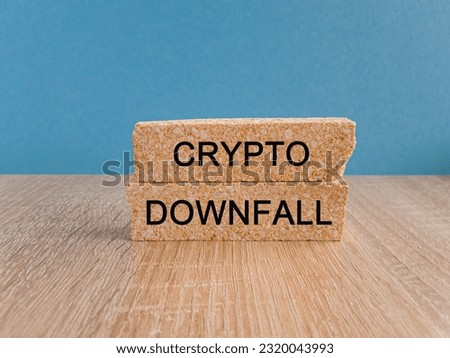 Crypto downfall symbol. Concept words Cryptos downfall on brick blocks. Beautiful wooden table light blue background. Business and crypto downfall concept. Copy space.