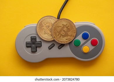 Crypto Gaming Concept. Video Game Controller With A Bitcoin Cryptocurrency Coin