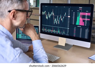 Crypto Trader Investor Analyst Looking At Computer Screen Analyzing Financial Graph Data On Pc Monitor, Thinking Of Online Stock Exchange Market Trading Investment Global Risks, Over Shoulder View.