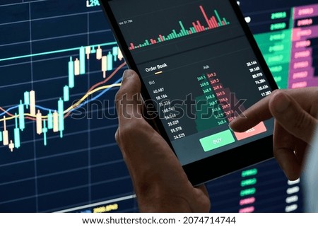 Crypto trader investor broker holding finger on buy or sell button executing financial stock trade market trading order thinking of cryptocurrency or shares assets investment risks and profit concept.