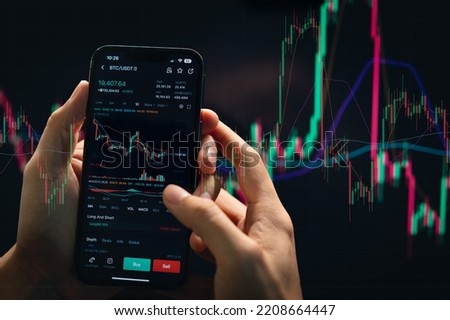 Crypto trader investor using smart phone app financial stock trade market trading order to buy or sell cryptocurrency.