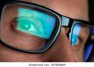 Crypto Trader Wearing Eyeglasses Working Looking At Computer Screen Reflecting In Glasses Analyzing Online Trading Stock Exchange Market Financial Data Charts. Close Up Eye In Spectacles Reflection.